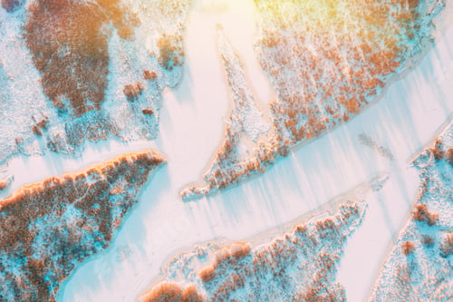 Preview: Aerial view forest woods and river landscape in winter day. Bird's eye view of small island and