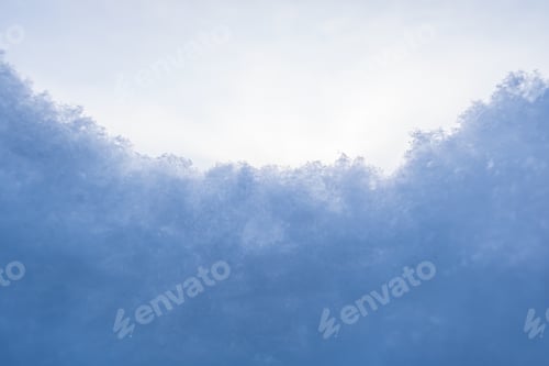 Preview: Fluffy snow against the sky, on a frosty winter evening. Copy space. Abstract background.