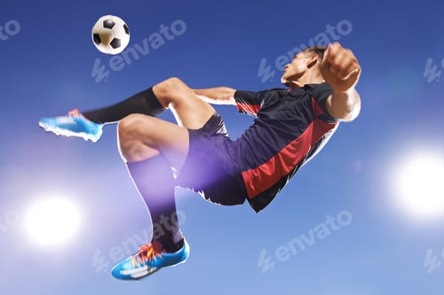 Preview: Hes got game. Shot of a young footballer kicking a ball in mid-air.