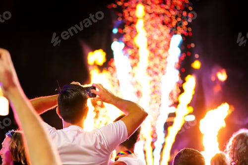 Preview: Crowd of people watching the fireworks and taking photos with their phone during the Mardi Gras