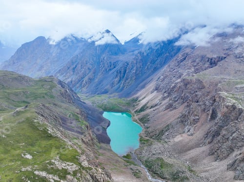 Preview: Turquoise alpine lake nestled in a dramatic rocky valley