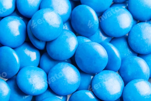 Preview: Close up on pile blue milk chocolate candies crisp shell
