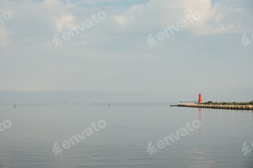 Preview: Lighthouse on blue sea line. Waves on sunny day on Baltic sea. Gdansk Poland. Swimming by ship to