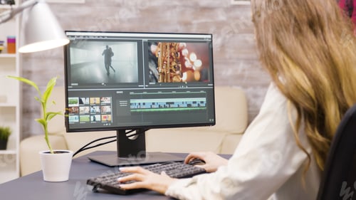 Preview: Creative female filmmaker working on post production of a movie