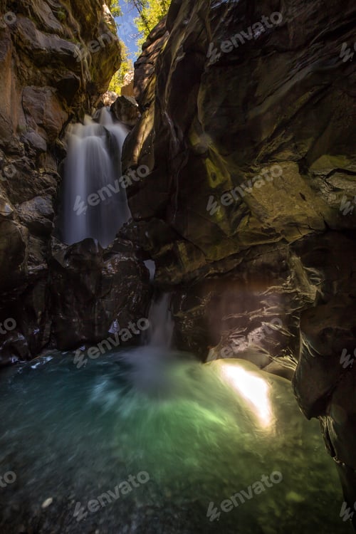 Preview: Vertical shot of water wall from the top of the cliff