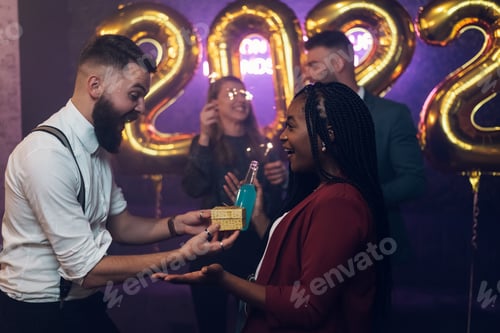 Preview: Happy beautiful couple celebrate New Year's Eve and exchanging gifts