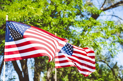 Preview: Closeup shot of united stated flag on a pole with a blurred background