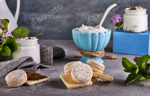 Preview: Wooden cutting board topped with macarons , chocolate , yogurt and grapes