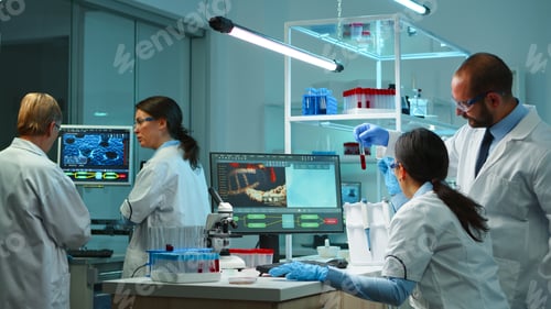 Preview: Research scientists working on pc analyzing genetic material samples