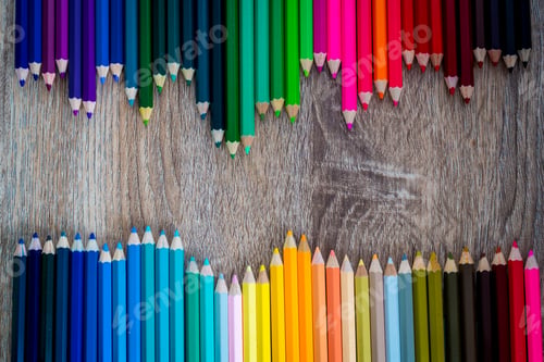 Preview: Multi Color pencils in scale with rainbow style isolated on wooden background