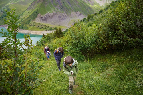 Preview: Father and sons hiking together, long walk, summer activities for family in the mountains.