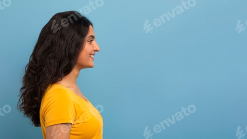 Preview: Profile studio shot of curly young indian woman
