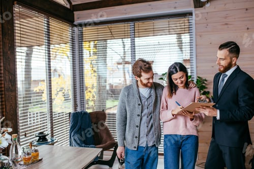 Preview: Couple customers signing papers with mortgage broker making purchase deal