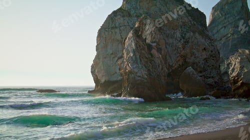 Preview: Stone rock Portugal Ursa beach washed calm Atlantic ocean. View of high cliff.
