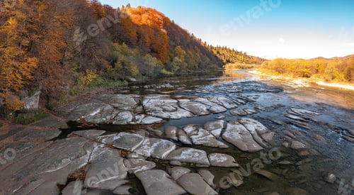 Preview: Shallow mountain river at foothill with terracotta forests