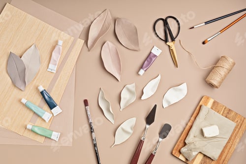 Preview: Hobby background with handmade clay leaves, paint brushes and art accessories