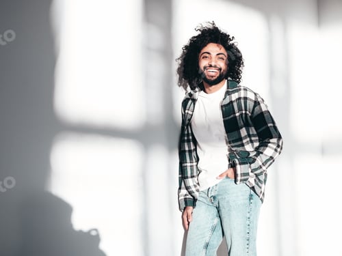 Preview: Handsome smiling hipster man posing in studio