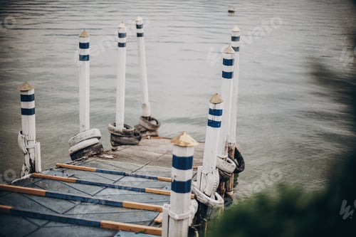 Preview: Beautiful old wooden dock with aged columns in white and blue colors
