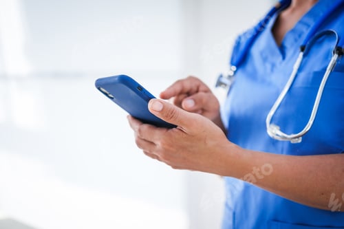 Preview: An Asian female nurse stands by a research desk in a hospital, consulting a doctor to verify