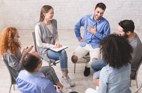 Preview: Cheerful man appreciates support of people at rehab group meeting