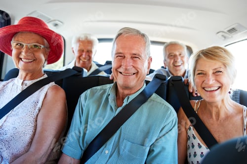 Preview: Portrait Of Senior Friends Sitting In Back Of Van Being Driven To Vacation