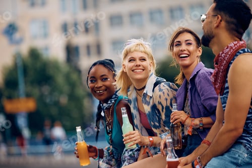 Preview: Happy woman and her friends talking while waiting for open air music festival to begin.