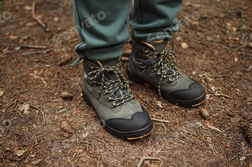 Preview: Woman Standing Outdoors Wearing Hiking Boots on Forest Ground