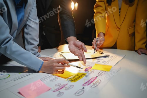Preview: Business team working late in the office using sticky notes and brainstorming new business plan