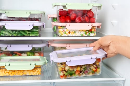 Preview: Woman taking box with vegetable mix from refrigerator, closeup