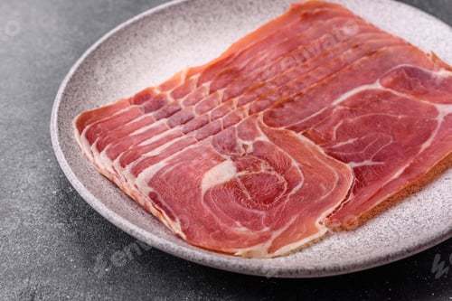 Preview: Meat, ham, jamon, or prosciutto sliced for breakfast bruschetta. Sliced ham, jamon, or prosciutto