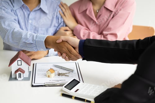 Preview: Real estate agents shake hands with customers after signing a legal home purchase agreement.