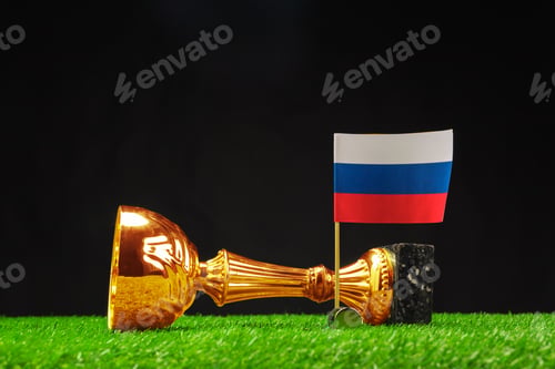 Preview: Golden trophy and Russian flag displayed on grass with dark background