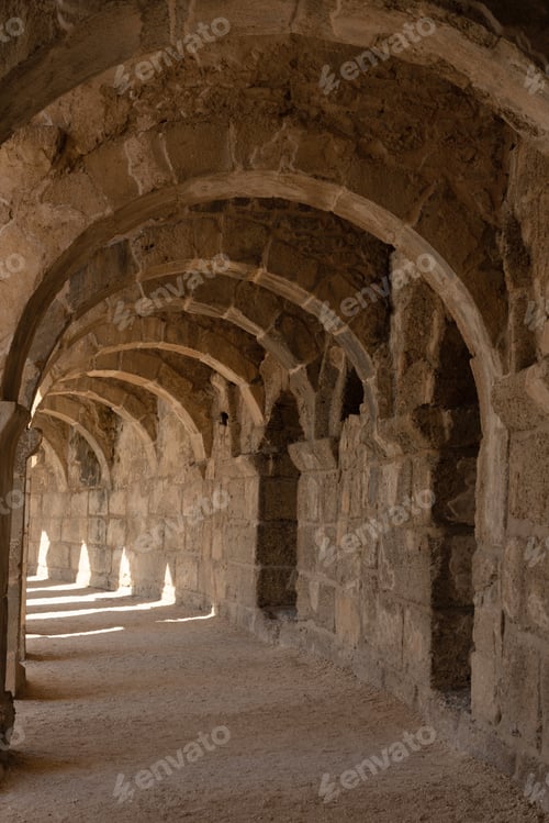 Preview: Light and shadow in ancient building with many arches in it.