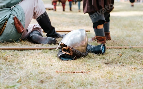 Preview: Close-up of a steel old helmet with protection lying on the grass