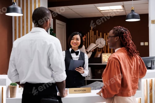 Preview: Receptionist registering guests in lobby