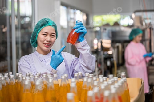 Preview: Worker Checking quality or checking stock of glass bottle in beverage factory.