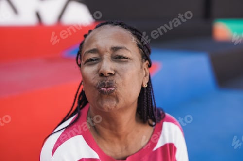 Preview: Happy african senior woman in the city
