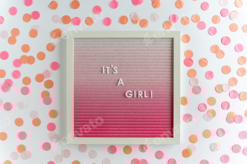 Preview: pink letter board with the words It's a girl, with confetti