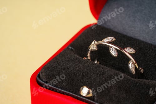 Preview: Golden ring in red jewelry box close up