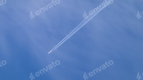 Preview: a jet plane flies through the blue sky on a sunny day
