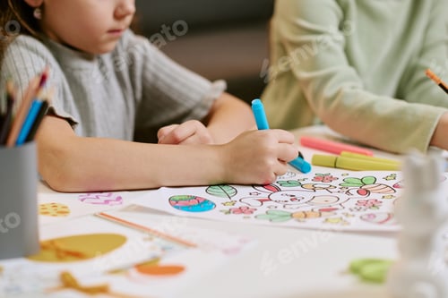 Preview: Girl Drawing Colorful Picture While Sitting at Table Indoors
