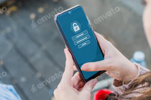 Preview: Closeup of a person holding a smartphone with a security app on it - concept of cybersecuri