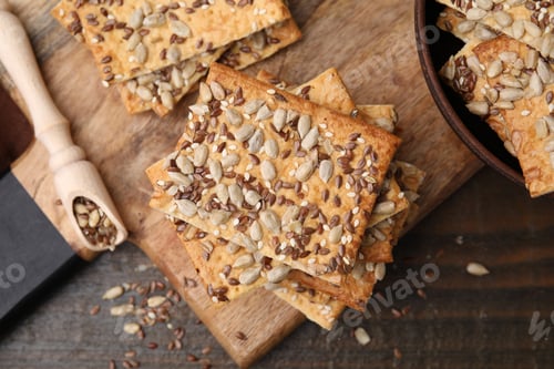 Preview: Cereal crackers with flax, sunflower and sesame seeds on wooden table, top view