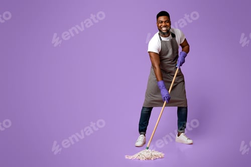 Preview: Household Chores. Happy African Janitor Washing Floor With Mop And Smiling