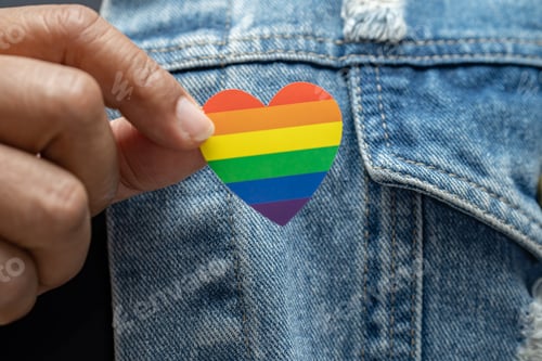 Preview: Asian lady wearing blue jean jacket or denim shirt and holding rainbow color flag heart, symbol