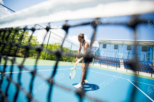 Preview: Young woman playing tennis