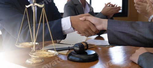 Preview: Businessman shaking hands to seal a deal with his partner lawyers or attorneys discussing a contract