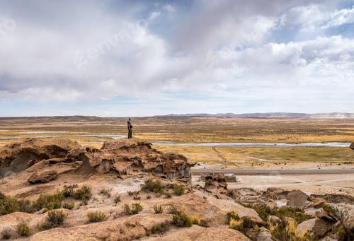 Preview: Man standing on the edge of rocky hill in Bolivia