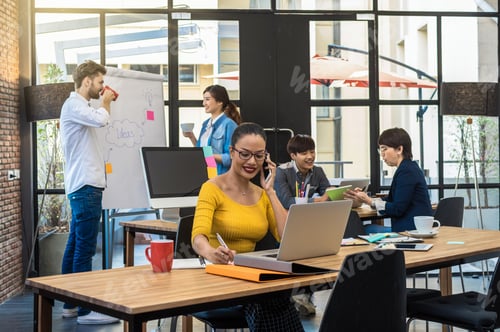 Preview: Portrait of Businesswoman working with computer over the photo blurred of Group Of Asian