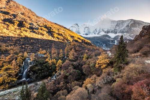 Preview: Mount Yangmaiyong with waterfall in autumn forest at evening. Yading nature reserve